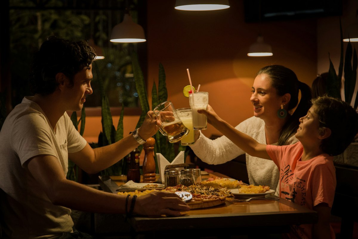 Guests raising their glasses in a toast over dinner